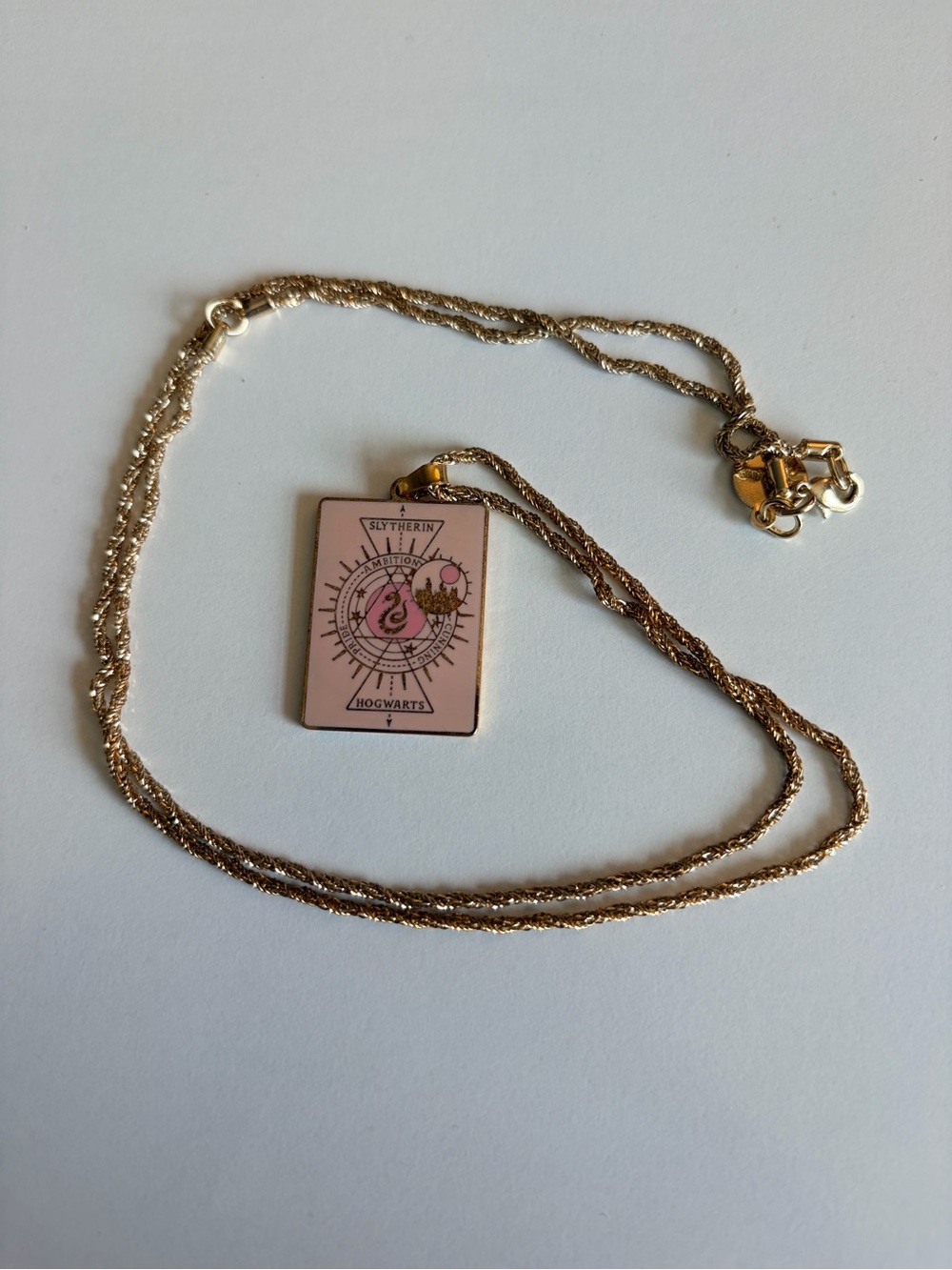 Alex and Ani pink Slytherin pendant. 20+ inch gold plated twist chain.